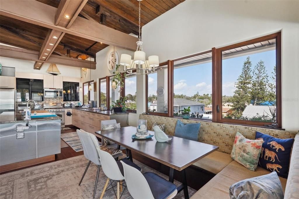 Chandelier, Dining room, Interior, Kitchen, Living room, Pendant Lights, Recessed Lighting, Stainless Steel Appliances, Water, Wooden Beams, Wooden Ceilings, Wood Texture Flooring