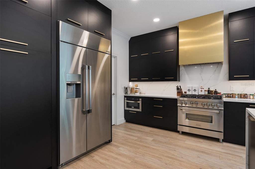 Interior, Kitchen, Marble Walls, Recessed Lighting, Stainless Steel Appliances, Wood Texture Flooring