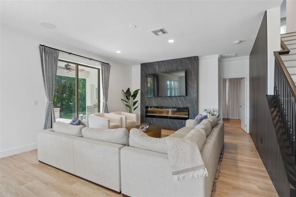 Fireplace, Interior, Living room, Marble Walls, Recessed Lighting, Wood Texture Flooring