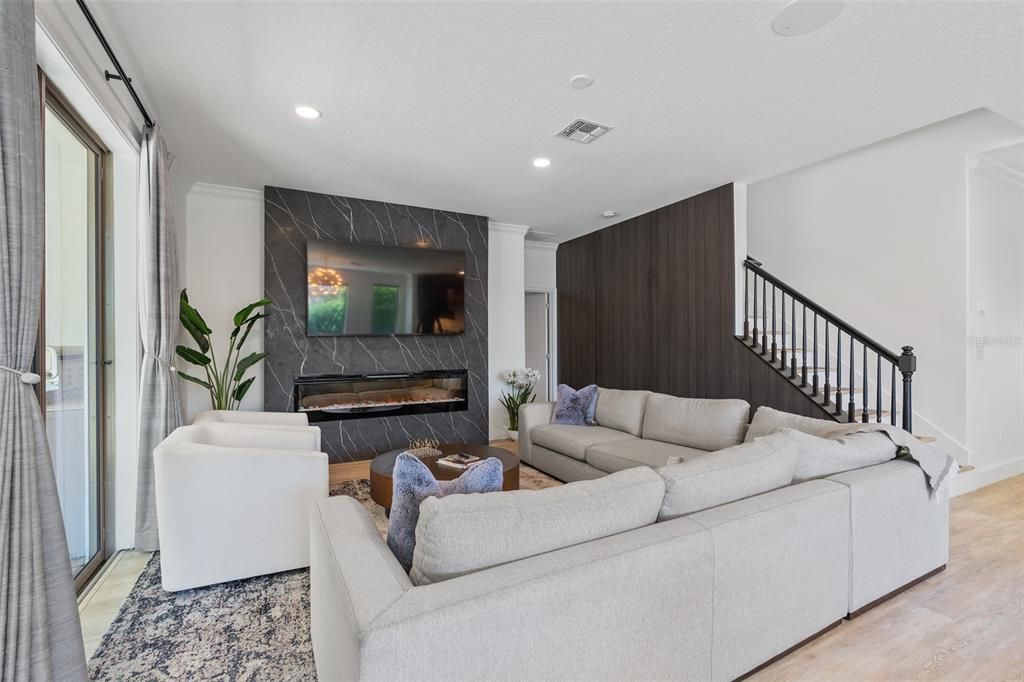 Fireplace, Interior, Living room, Marble Walls, Recessed Lighting, Wood Texture Flooring