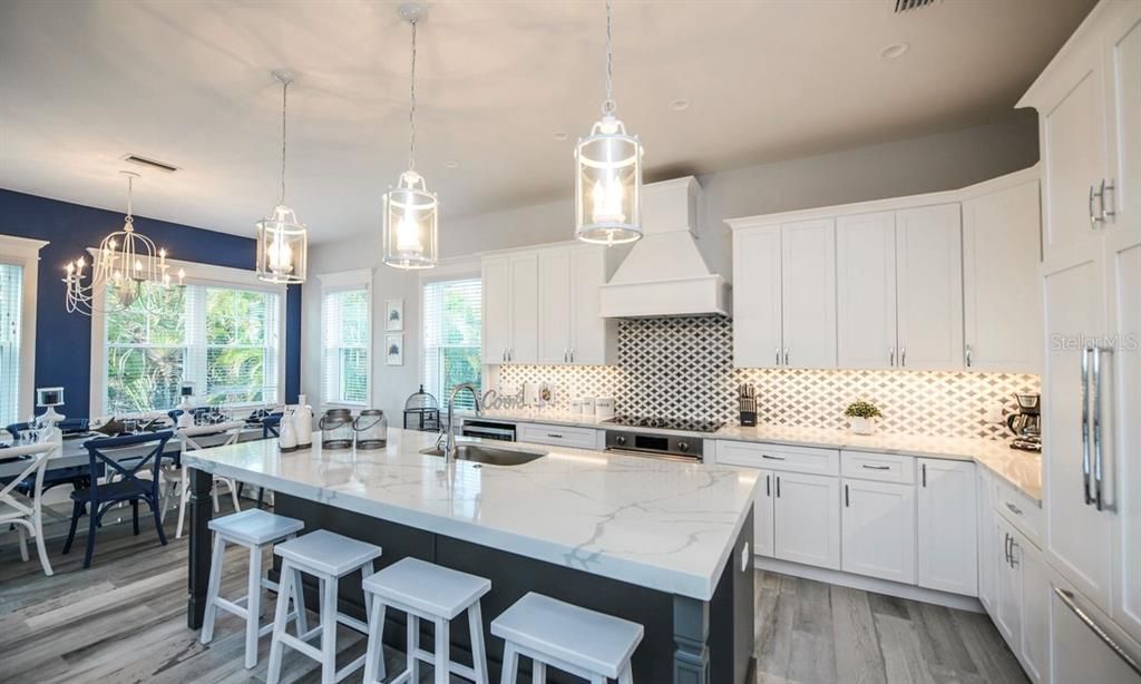 Chandelier, Dining room, Interior, Kitchen, Pendant Lights, Recessed Lighting, Stainless Steel Appliances, Wood Texture Flooring