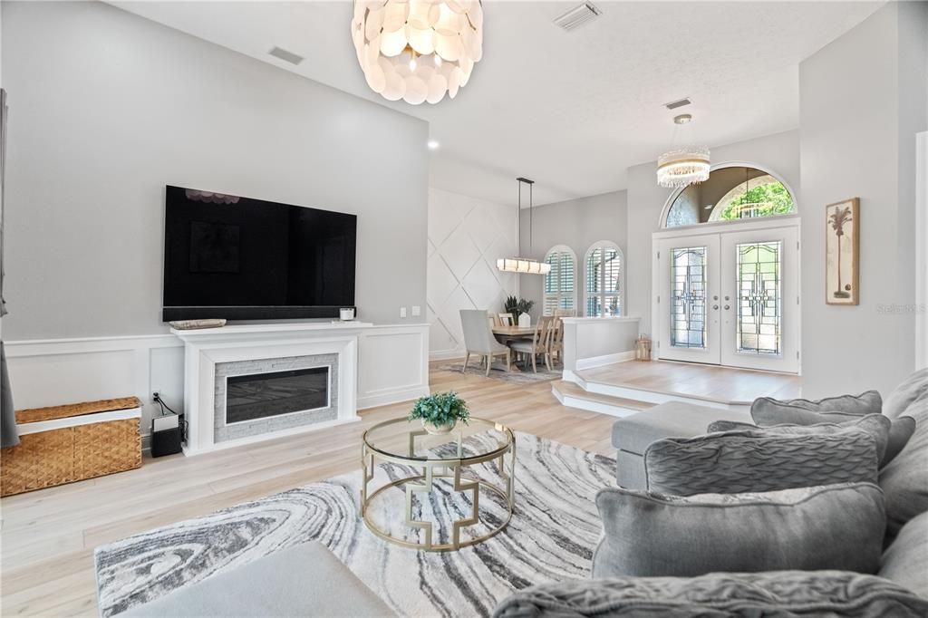 Chandelier, Dining room, Fireplace, Interior, Living room, Pendant Lights, Recessed Lighting, Wood Texture Flooring