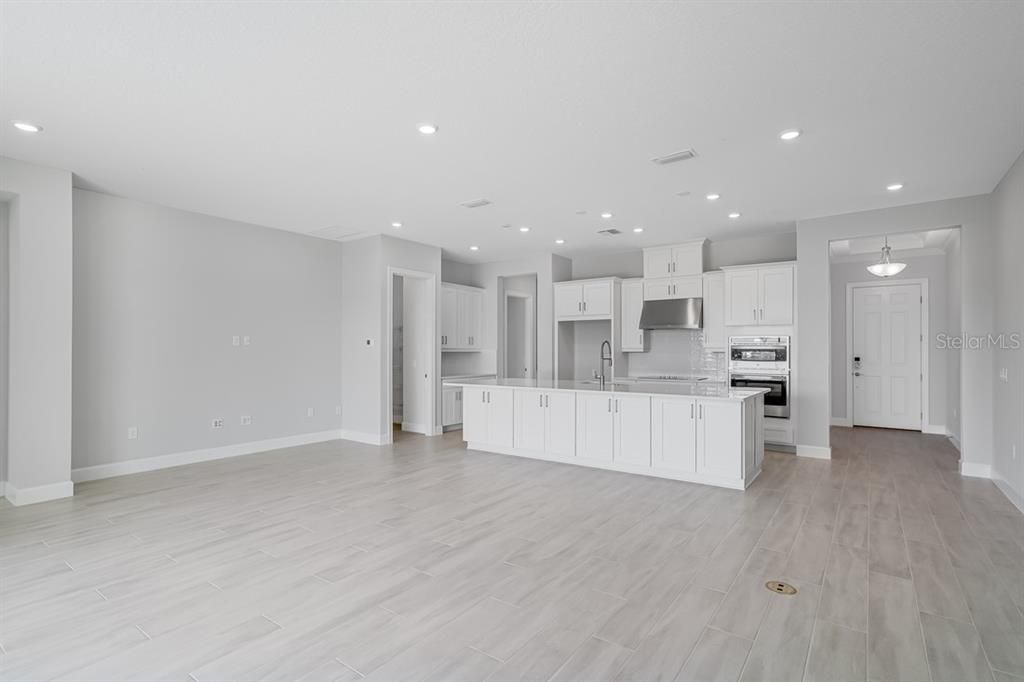 Empty room, Interior, Kitchen, Pendant Lights, Recessed Lighting, Stainless Steel Appliances, Wood Texture Flooring