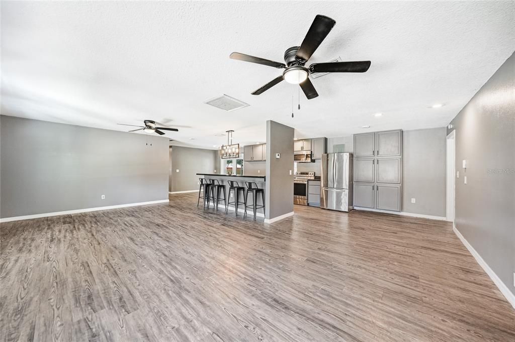Empty room, Interior, Kitchen, Pendant Lights, Recessed Lighting, Stainless Steel Appliances, Wood Texture Flooring