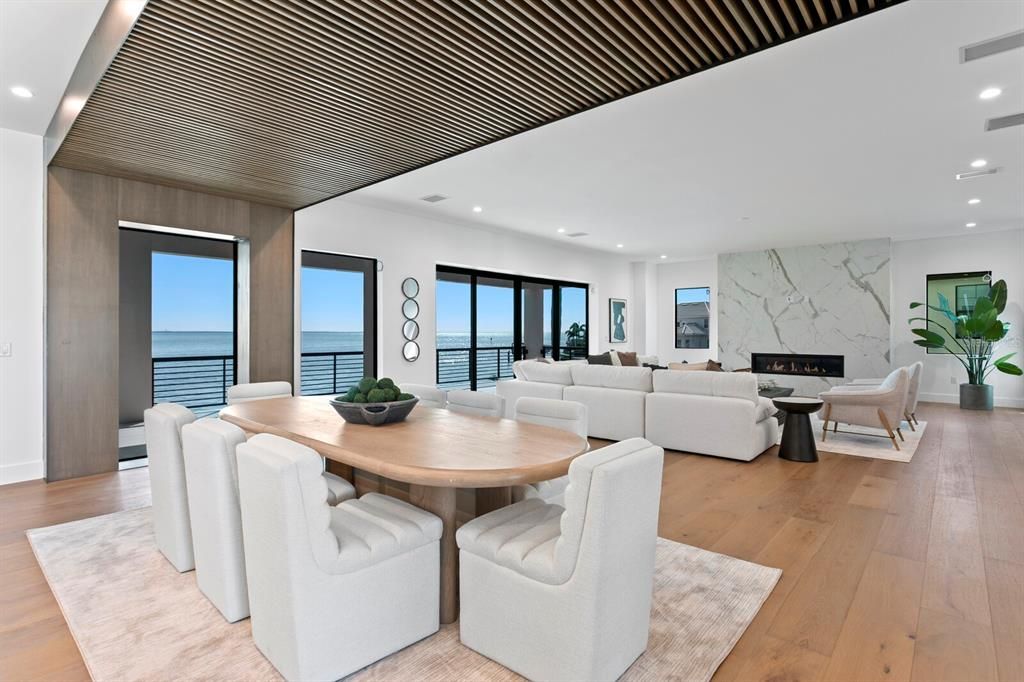 Dining room, Fireplace, Interior, Living room, Recessed Lighting, Water, Wood Texture Flooring