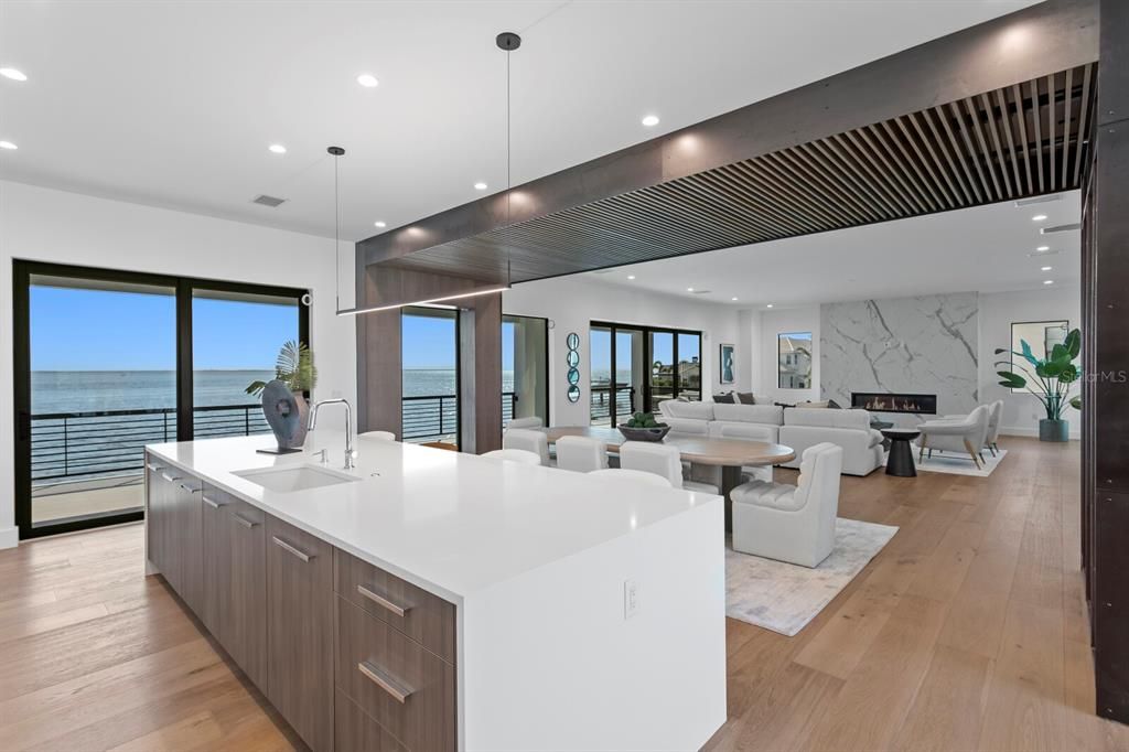 Dining room, Fireplace, Interior, Kitchen, Living room, Marble Walls, Pendant Lights, Recessed Lighting, Water, Wood Texture Flooring