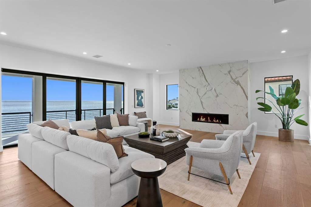 Fireplace, Interior, Living room, Marble Walls, Recessed Lighting, Water, Wood Texture Flooring