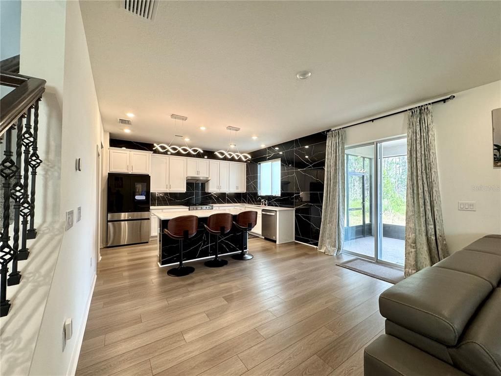 Interior, Kitchen, Marble Walls, Pendant Lights, Recessed Lighting, Stainless Steel Appliances, Wood Texture Flooring