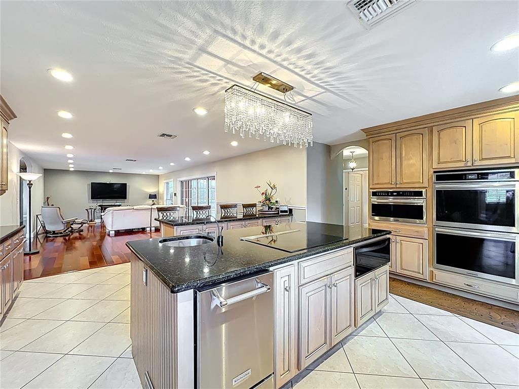 Chandelier, Fireplace, Interior, Kitchen, Living room, Recessed Lighting, Wood Texture Flooring