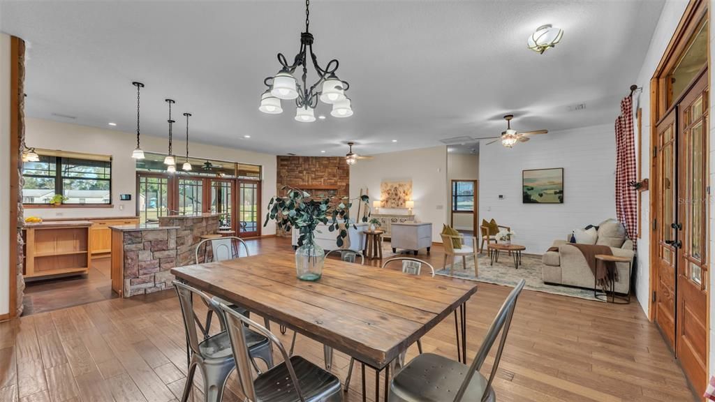 Chandelier, Dining room, Fireplace, Interior, Kitchen, Living room, Pendant Lights, Recessed Lighting, Stone Walls, Wood Texture Flooring