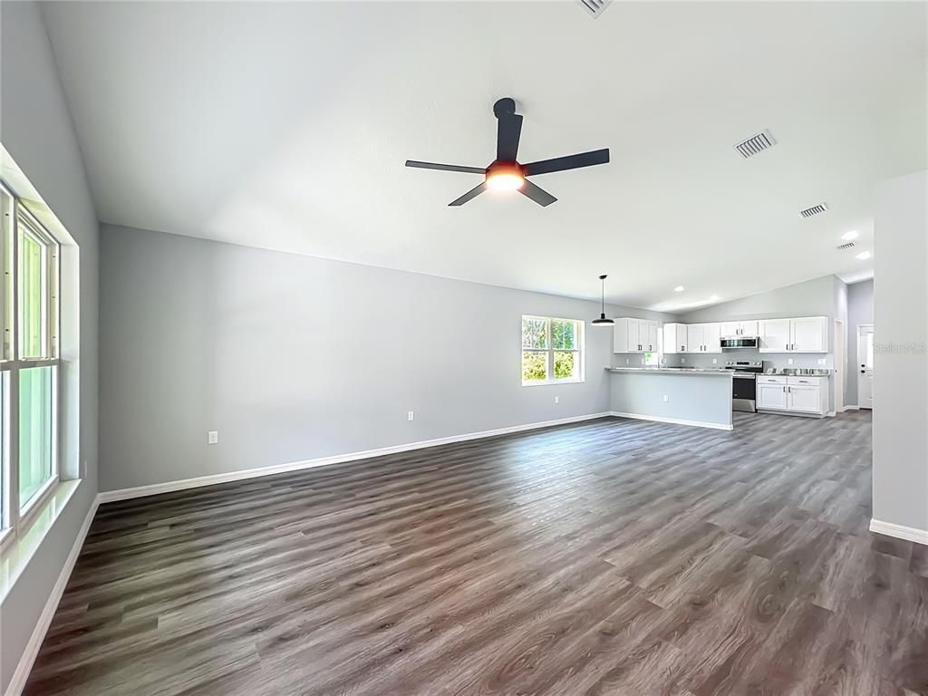 Empty room, Interior, Kitchen, Pendant Lights, Recessed Lighting, Stainless Steel Appliances, Wood Texture Flooring
