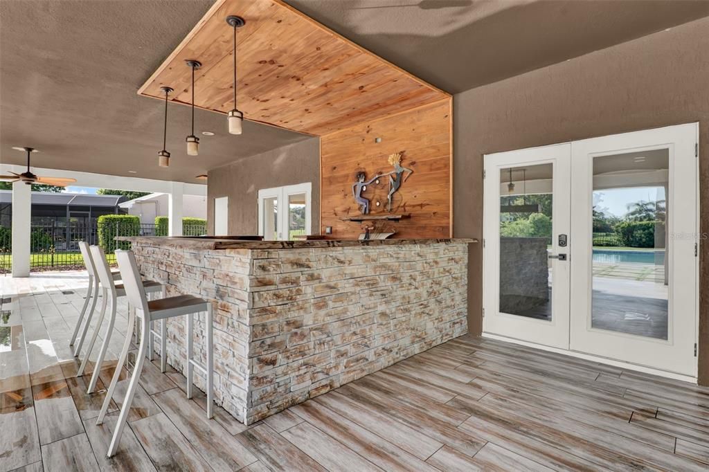 Exterior, Outdoor Kitchen, Pendant Lights, Wood Texture Flooring, Wooden Walls
