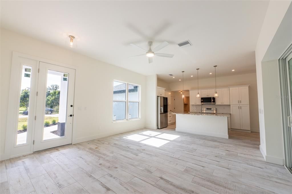 Empty room, Interior, Kitchen, Pendant Lights, Recessed Lighting, Stainless Steel Appliances, Wood Texture Flooring