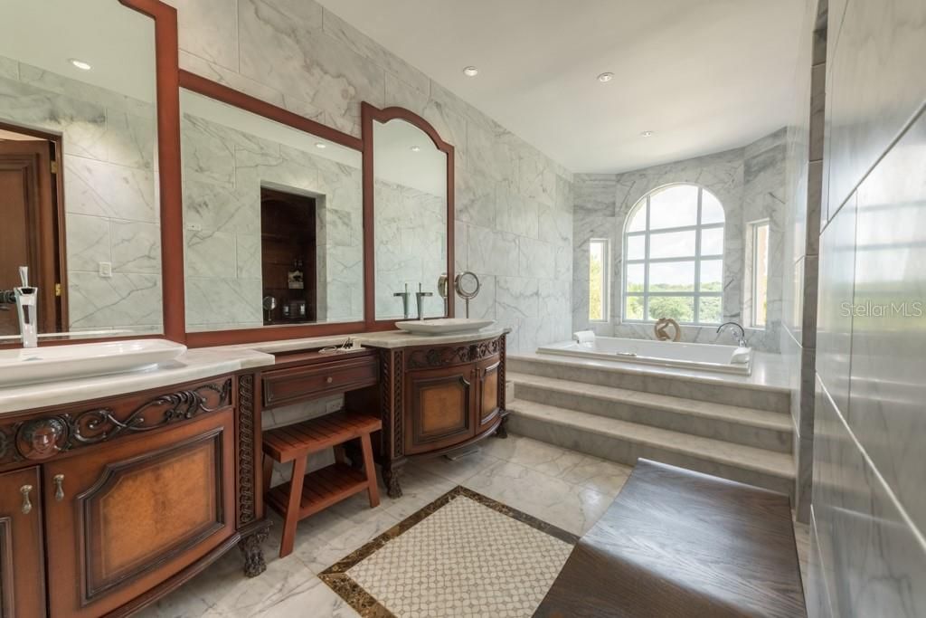 Bathroom, Dual Sink Vanities, Interior, Marble, Marble Walls, Recessed Lighting, Wood Texture Flooring