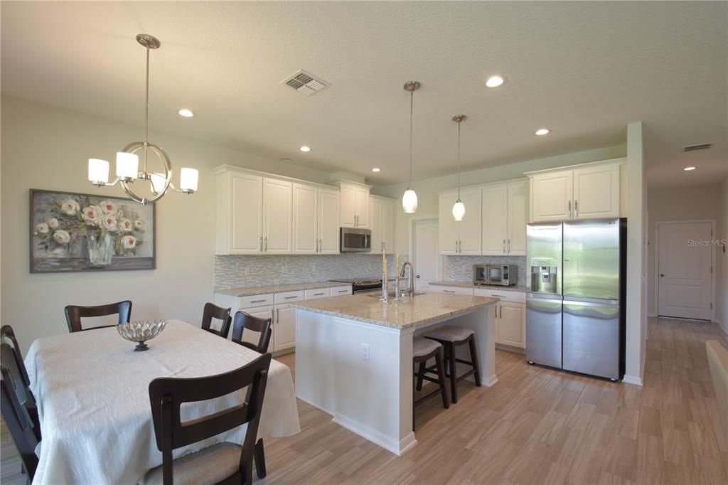 Dining room, Interior, Kitchen, Pendant Lights, Recessed Lighting, Stainless Steel Appliances, Wood Texture Flooring