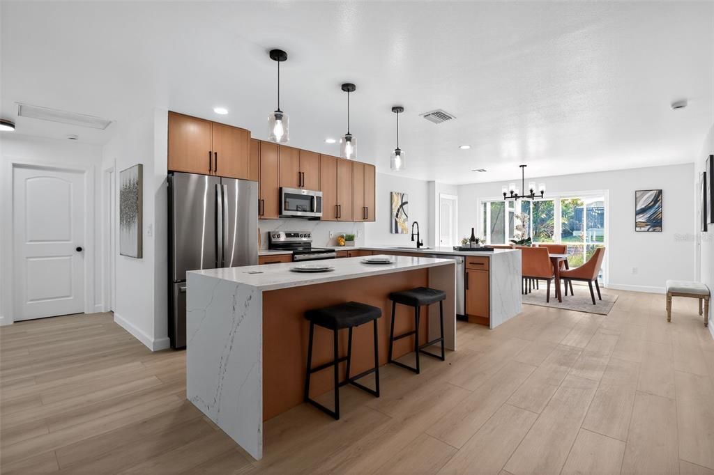 Dining room, Interior, Kitchen, Pendant Lights, Recessed Lighting, Stainless Steel Appliances, Wood Texture Flooring