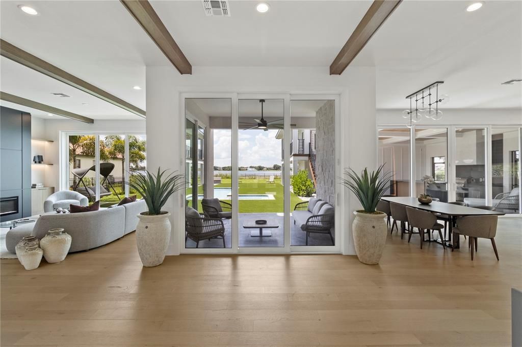 Dining room, Fireplace, Interior, Living room, Pendant Lights, Recessed Lighting, Water, Wooden Beams, Wood Texture Flooring
