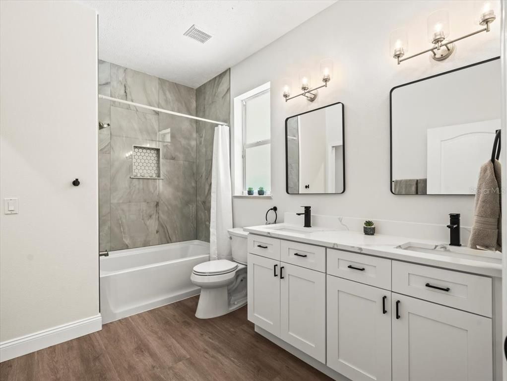 Bathroom, Dual Sink Vanities, Glass Shower, Interior, Marble Walls, Wood Texture Flooring