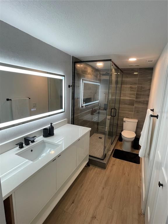 Bathroom, Dual Sink Vanities, Glass Shower, Interior, Recessed Lighting, Wood Texture Flooring