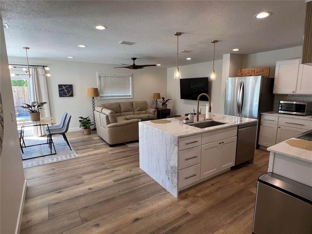 Dining room, Interior, Kitchen, Living room, Pendant Lights, Recessed Lighting, Stainless Steel Appliances, Wood Texture Flooring