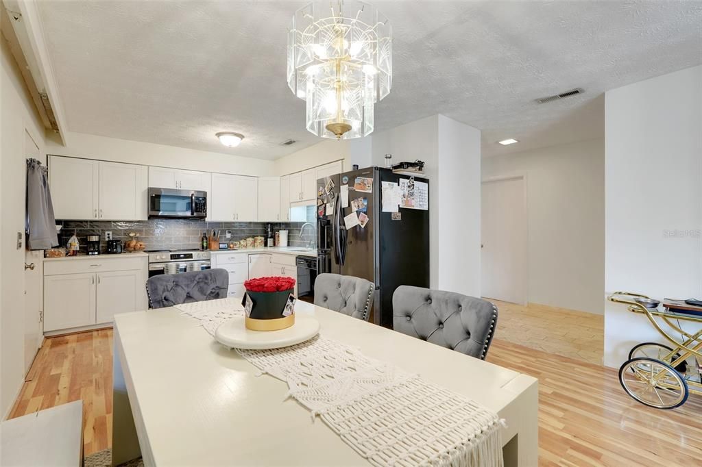 Chandelier, Dining room, Interior, Kitchen, Recessed Lighting, Stainless Steel Appliances, Wood Texture Flooring