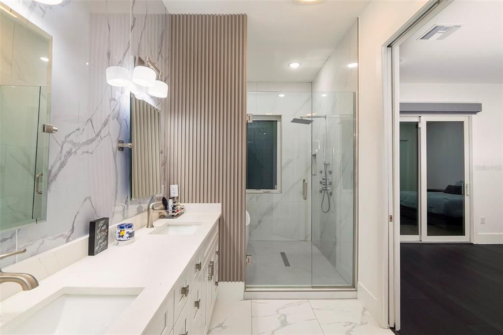 Bathroom, Dual Sink Vanities, Glass Shower, Interior, Marble, Marble Walls, Pendant Lights, Recessed Lighting