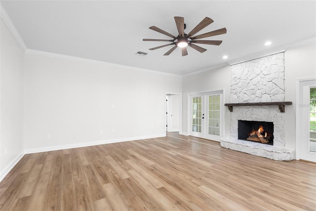 Empty room, Fireplace, Interior, Recessed Lighting, Stone Walls, Wood Texture Flooring
