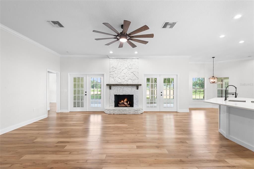 Empty room, Fireplace, Interior, Kitchen, Pendant Lights, Recessed Lighting, Wood Texture Flooring