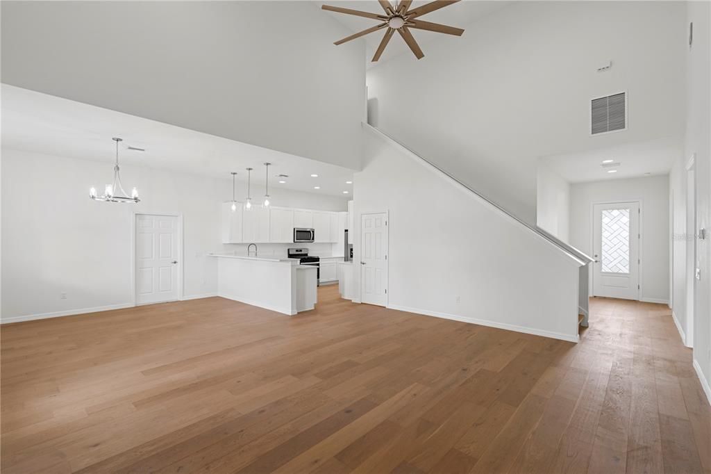 Empty room, Interior, Kitchen, Pendant Lights, Recessed Lighting, Stainless Steel Appliances, Wood Texture Flooring