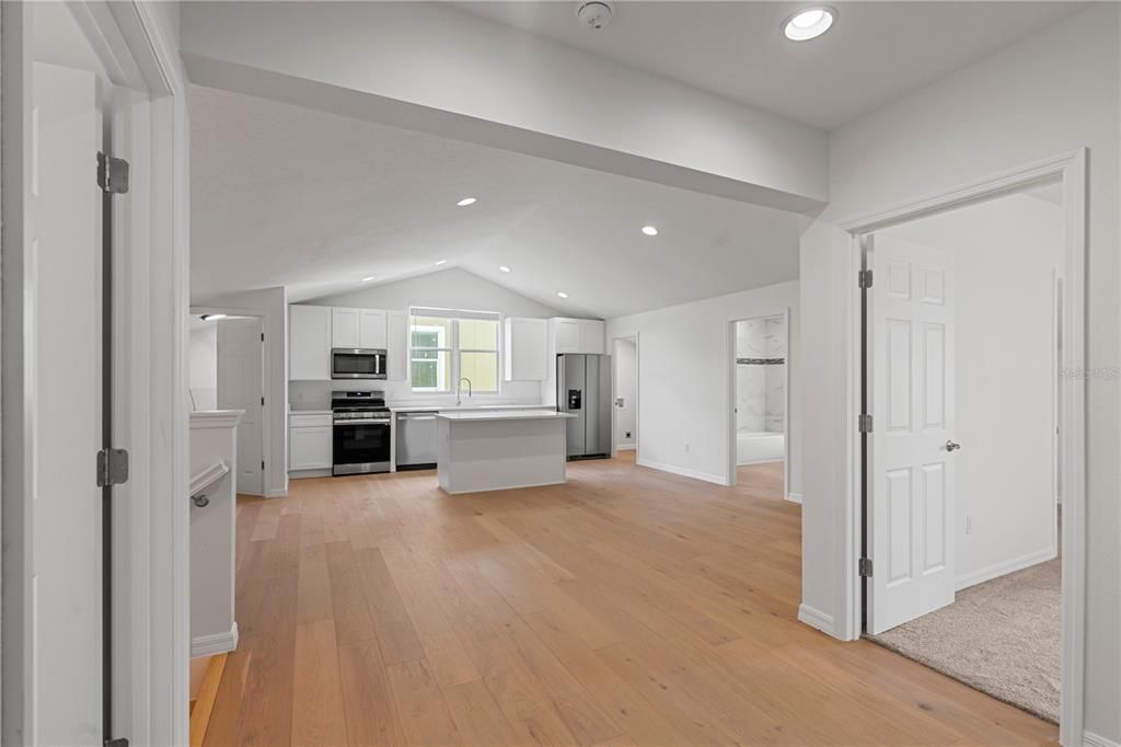 Empty room, Interior, Kitchen, Recessed Lighting, Stainless Steel Appliances, Wood Texture Flooring