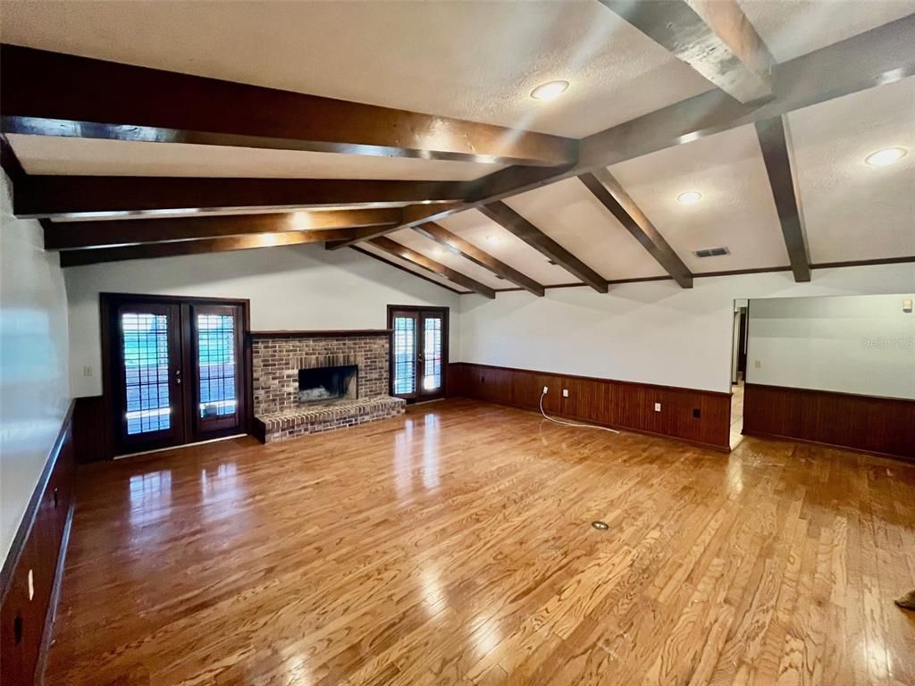 Empty room, Fireplace, Interior, Recessed Lighting, Stone Walls, Wooden Beams, Wood Texture Flooring