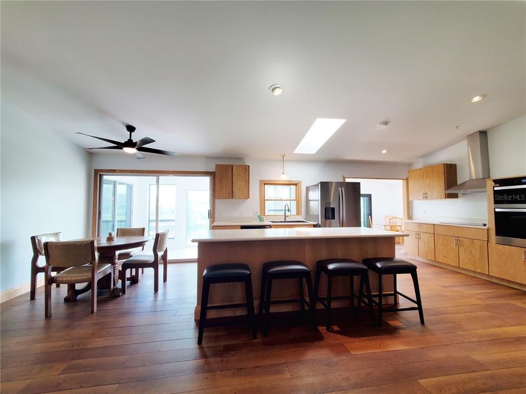 Dining room, Interior, Kitchen, Recessed Lighting, Stainless Steel Appliances, Wood Texture Flooring