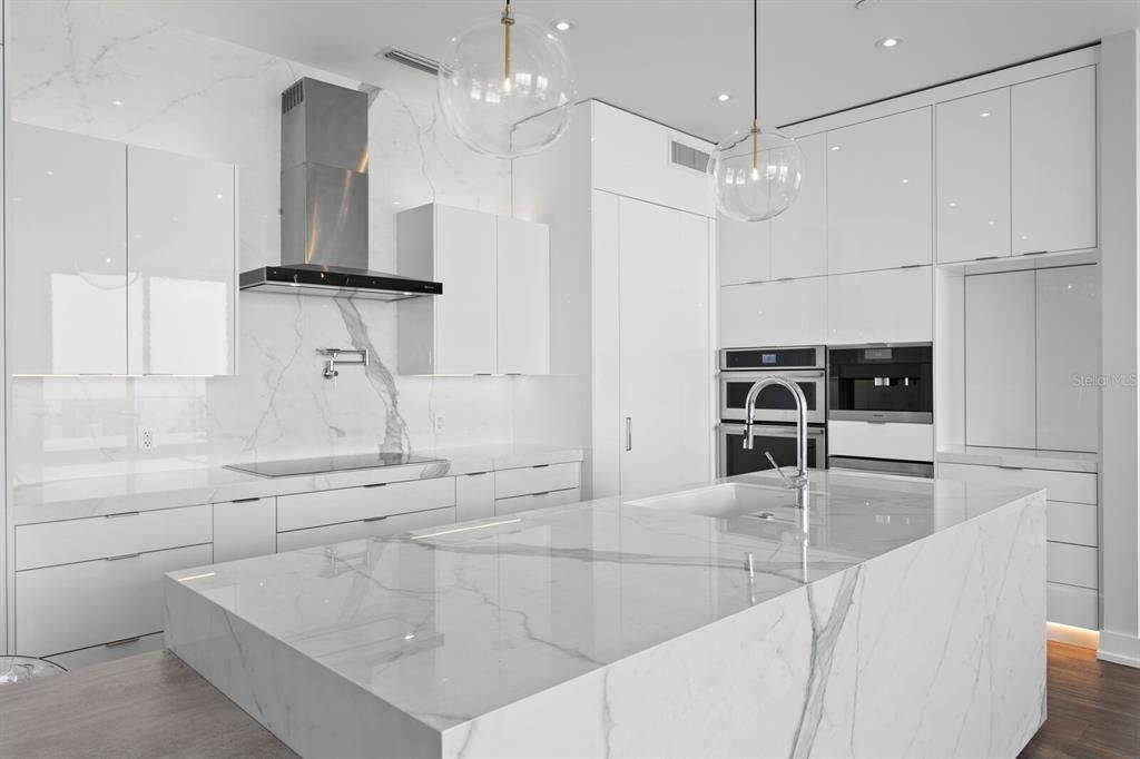 Interior, Kitchen, Marble Walls, Pendant Lights, Recessed Lighting, Stainless Steel Appliances, Wood Texture Flooring