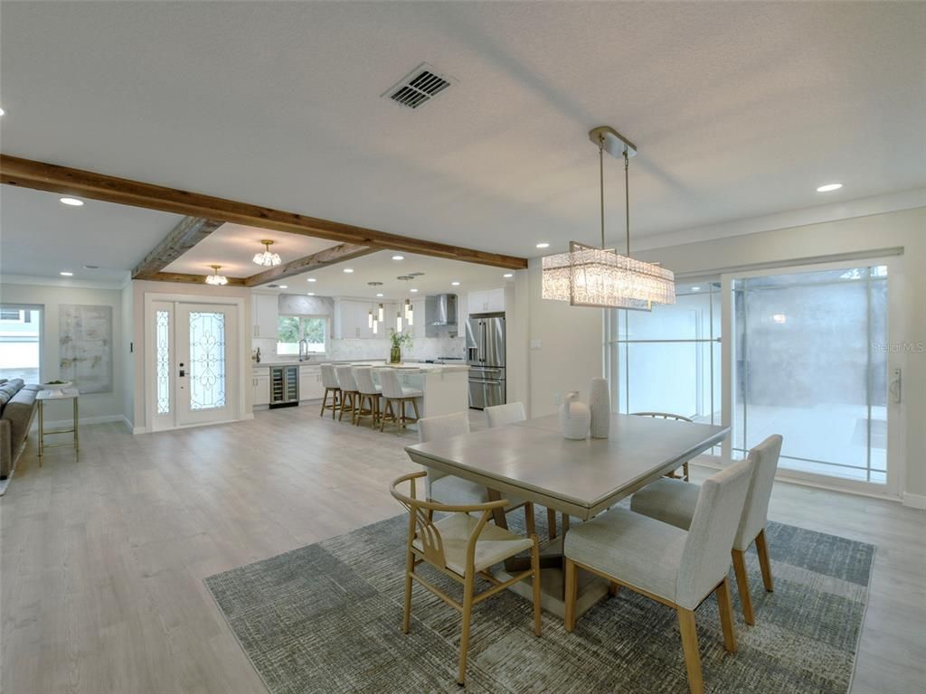 Chandelier, Dining room, Interior, Kitchen, Pendant Lights, Recessed Lighting, Stainless Steel Appliances, Wooden Beams, Wood Texture Flooring