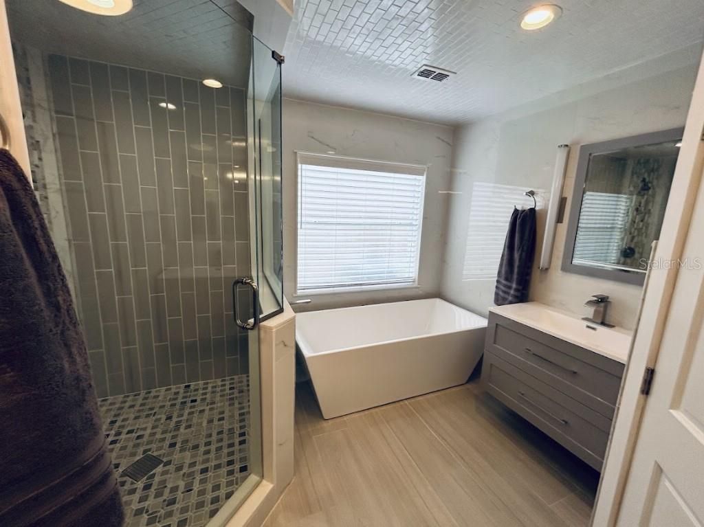 Bathroom, Free Standing Baths, Glass Shower, Interior, Recessed Lighting, Wood Texture Flooring