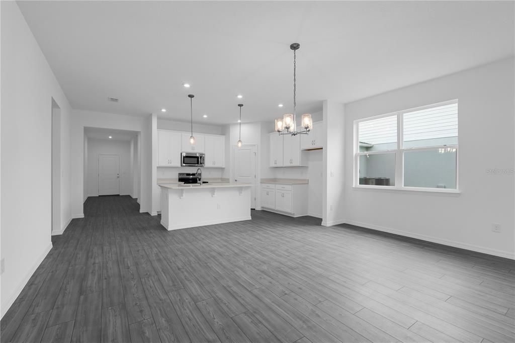 Empty room, Interior, Kitchen, Pendant Lights, Recessed Lighting, Stainless Steel Appliances, Wood Texture Flooring