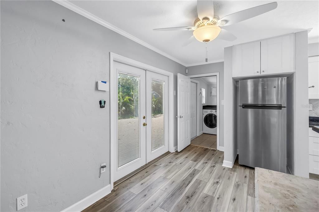 Empty room, Interior, Kitchen, Stainless Steel Appliances, Washer, Wood Texture Flooring