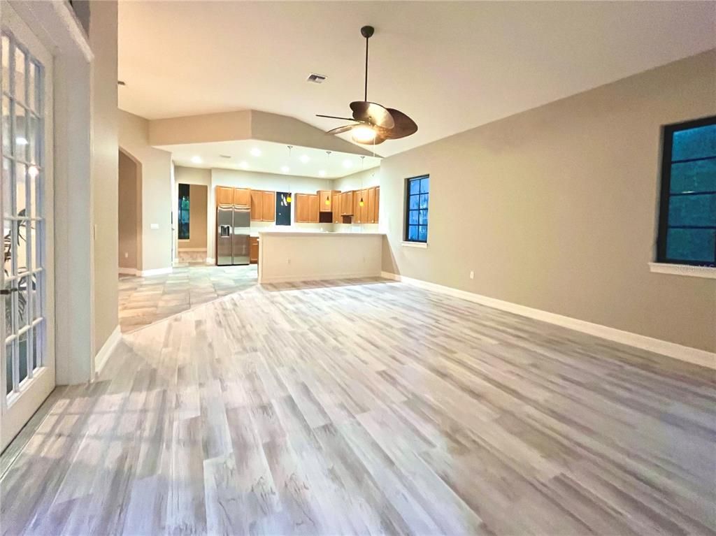Empty room, Interior, Kitchen, Recessed Lighting, Stainless Steel Appliances, Wood Texture Flooring