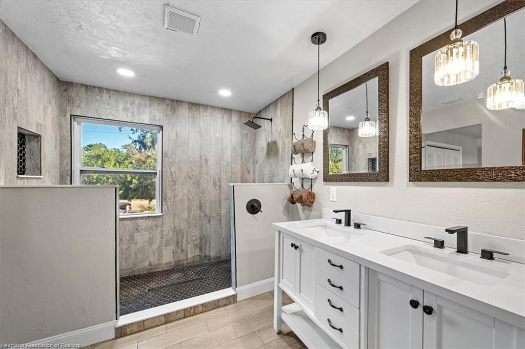Bathroom, Dual Sink Vanities, Glass Shower, Interior, Pendant Lights, Recessed Lighting, Wood Texture Flooring