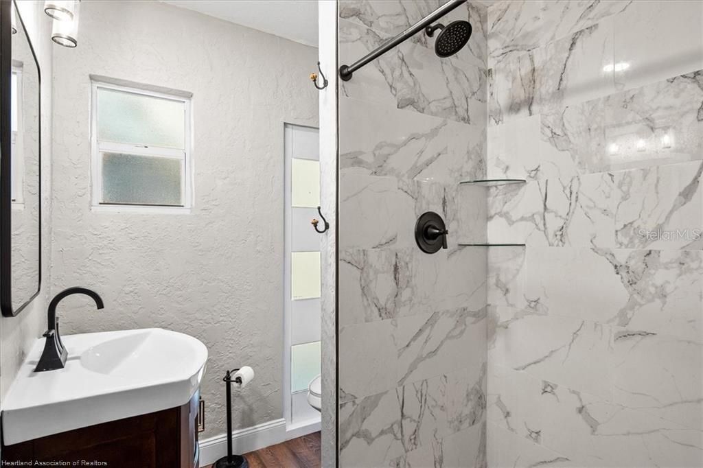 Bathroom, Glass Shower, Interior, Marble Walls, Wood Texture Flooring