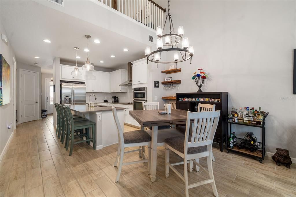 Chandelier, Dining room, Fireplace, Interior, Kitchen, Pendant Lights, Recessed Lighting, Stainless Steel Appliances, Wood Texture Flooring