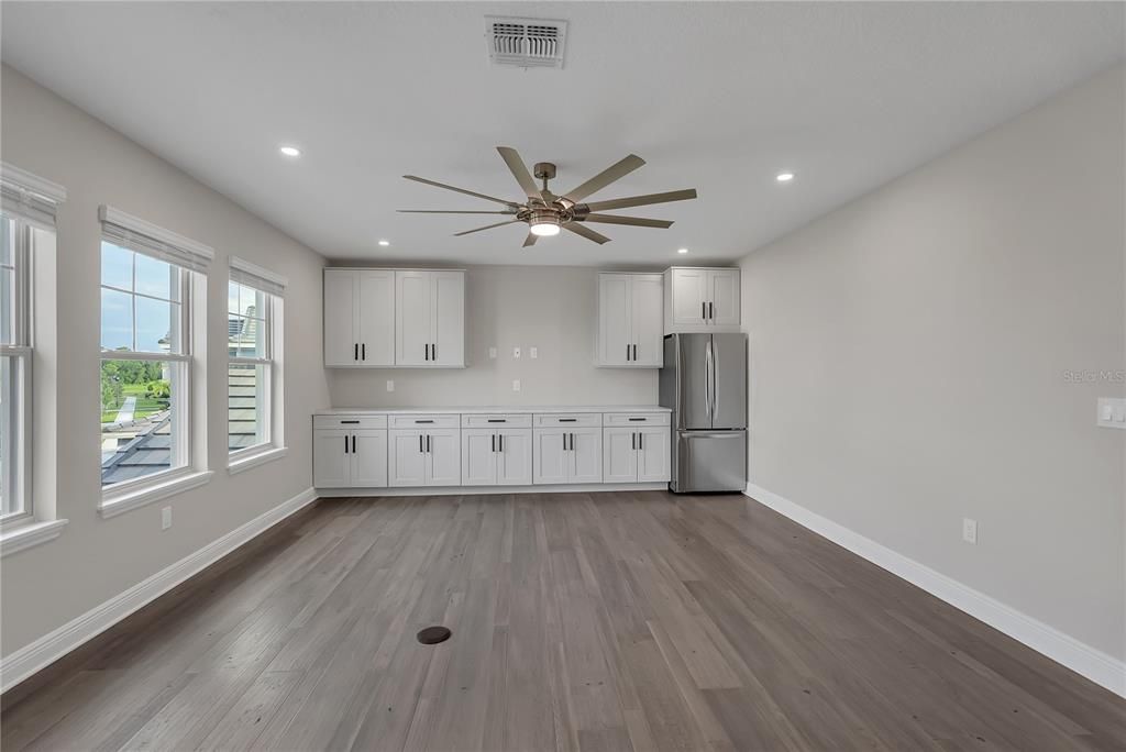 Empty room, Interior, Kitchen, Recessed Lighting, Stainless Steel Appliances, Wood Texture Flooring