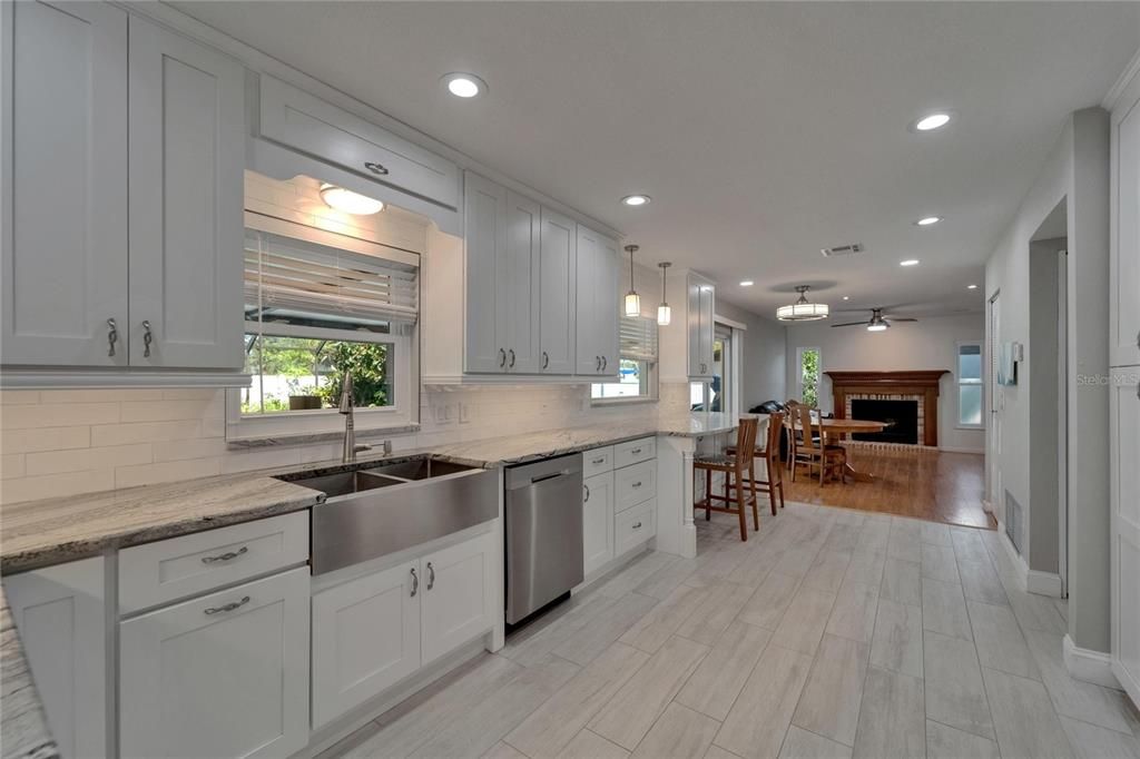 Dining room, Fireplace, Interior, Kitchen, Pendant Lights, Recessed Lighting, Stainless Steel Appliances, Wood Texture Flooring