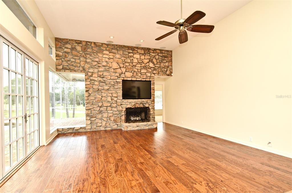 Empty room, Fireplace, Interior, Recessed Lighting, Stone Walls, Wood Texture Flooring