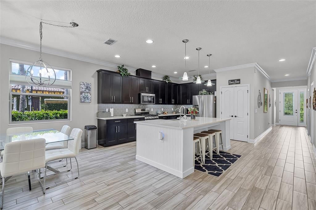 Dining room, Interior, Kitchen, Pendant Lights, Recessed Lighting, Stainless Steel Appliances, Wood Texture Flooring