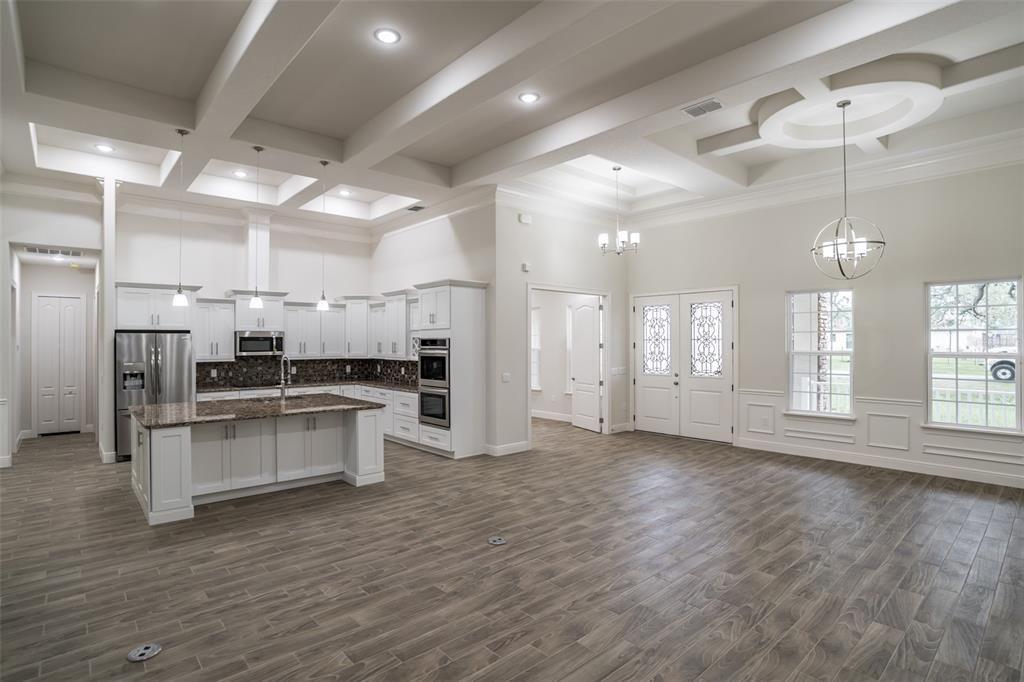 Chandelier, Empty room, Interior, Kitchen, Pendant Lights, Recessed Lighting, Stainless Steel Appliances, Wood Texture Flooring