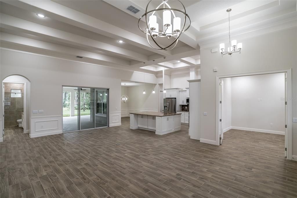 Chandelier, Empty room, Interior, Kitchen, Pendant Lights, Recessed Lighting, Stainless Steel Appliances, Wood Texture Flooring