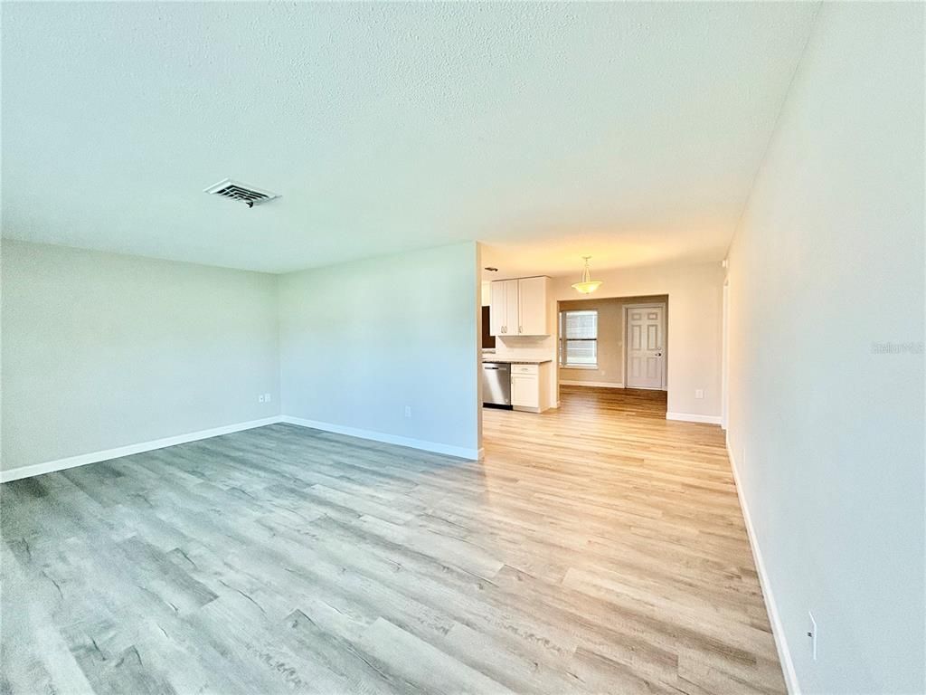 Empty room, Interior, Kitchen, Pendant Lights, Stainless Steel Appliances, Wood Texture Flooring