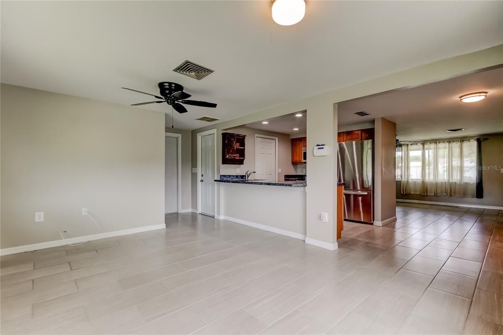 Empty room, Interior, Kitchen, Recessed Lighting, Stainless Steel Appliances, Wood Texture Flooring