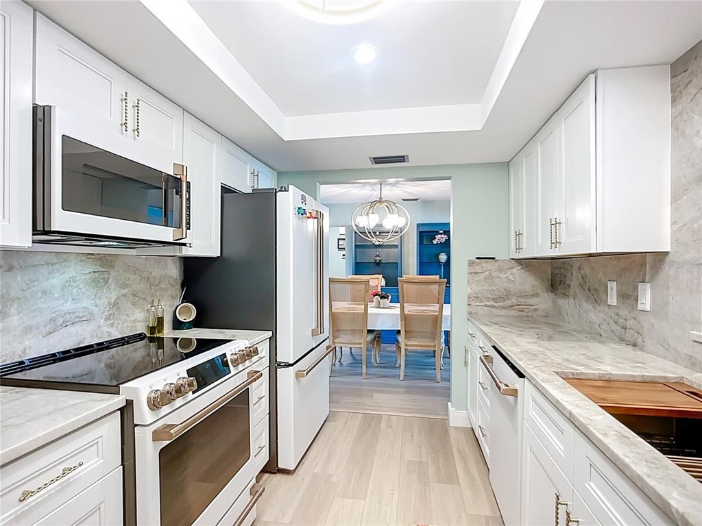 Chandelier, Dining room, Interior, Kitchen, Recessed Lighting, Stainless Steel Appliances, Wood Texture Flooring